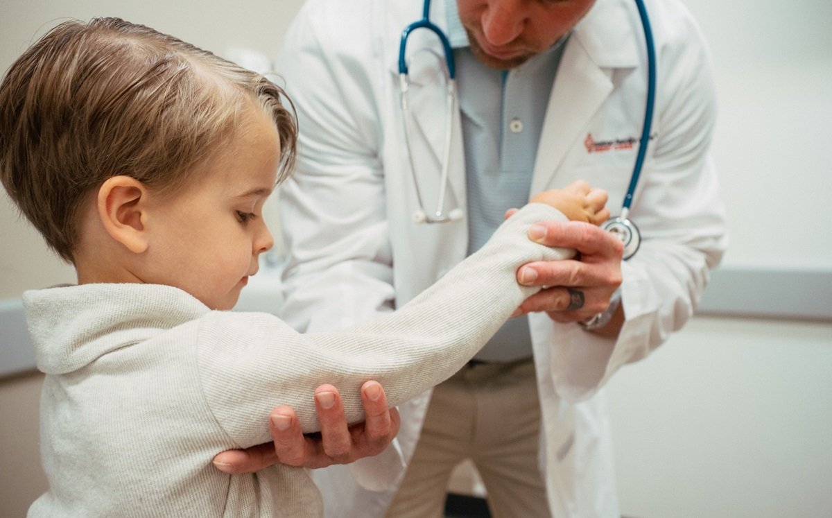 medical provider examining nurse maid elbow on toddler patient